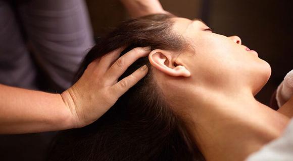 lady with head tilted to the side in head massage